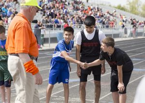 Good sportsmanship combined with competition at the DMPS Middle School track & field meet.