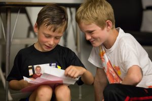 Downtown School big and little "buddies" share letters on the last day of school.