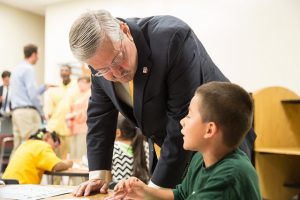 Governor Branstad talks with a student in the Starfish Academy summer program at King Elementary School.