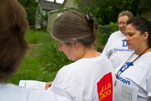 Volunteers complete a form after a successful home visit on Saturday's Graduation Walk.