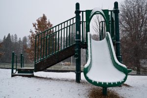 The first measurable snow of the 2014-15 school year begins to collect on playground equipment at Greenwood Elementary School.