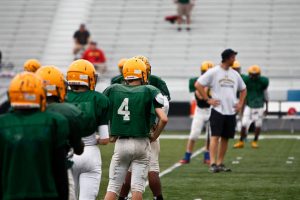 Hoover football players and coaches at a practice scrimmage before the start of the 2014 season.