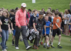 A DMPS 5th grader volunteers to caddy for PGA professional Tom Pernice, Jr.