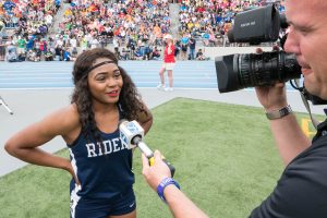 Briyana Carter of Roosevelt High School talks with the news media after winning the State 100m title, adding  to the legacy of Roughrider sprinters.