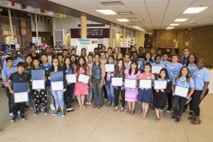 Students posed with certificates following an event that showcased the first year of Dream to Teach.