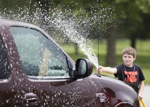 Students in the 21CCLC summer program at Meredith Middle School organized a car wash to raise money to support a long-time cafeteria worker.