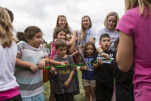 Moore students and teachers cut the ribbon to officially re-open the school.