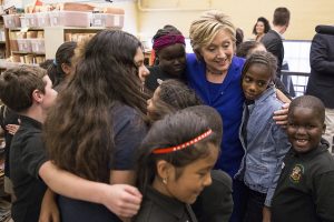 Students welcome presidential candidate Hillary Clinton to Moulton Elementary School.