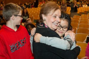 Holocaust survivor hugs a student after her presentation at Goodrell Middle School.