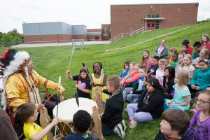 Students at Windsor Elementary School receive a lesson in some native American custom from 
