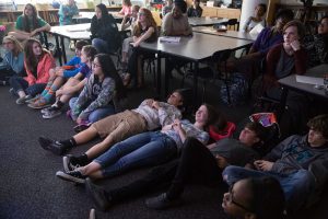 Students in Jill Gilbert's class get comfortable to watch her appearance on Jeopardy!