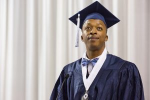 High school graduate in cap and gown