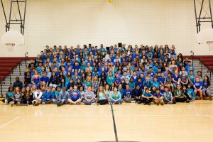 Large group of students wearing blue t-shirts.