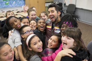 Actor John Lloyd Young with elementary school students