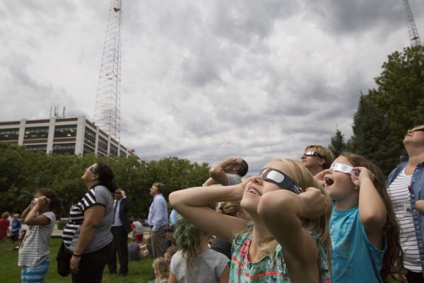 Students watch solar eclipse.