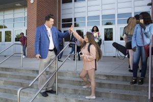 principal high fives a student