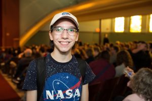 student dressed in NASA hat and shirt