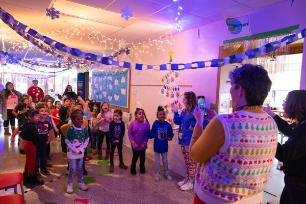 students walking through a hallway of festive decoration 