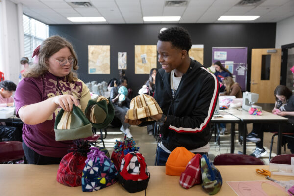 Students sewing winter hats